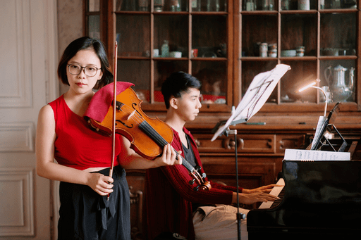 Yishi Zhao in front of a piano